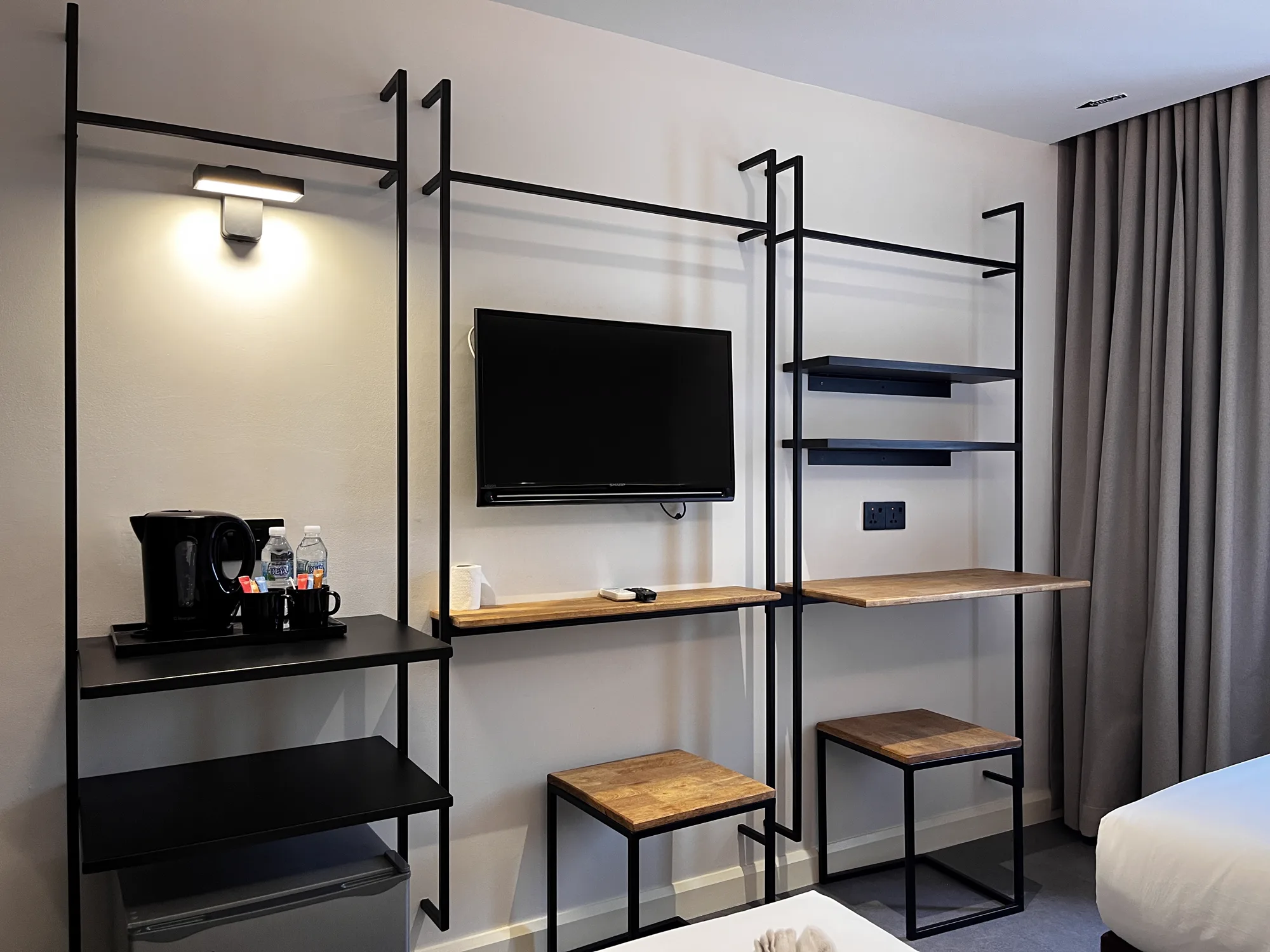 MyHotel guest-room media wall, desk and open wardrobe